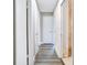 Hallway with gray flooring, white doors, neutral paint, and access to various rooms throughout the house at 2536 Nw 3Rd Ave, Ocala, FL 34475