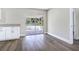 Living room featuring access to the screened-in porch, new wood floors, white cabinets, and neutral colored walls at 2536 Nw 3Rd Ave, Ocala, FL 34475