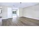 Spacious living room featuring gray flooring, neutral walls, modern lighting and an open floor plan flowing into the kitchen at 2536 Nw 3Rd Ave, Ocala, FL 34475