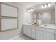 Elegant bathroom featuring a double vanity, large mirror, and a glass-enclosed shower at 2582 Winsome Way, Davenport, FL 33896