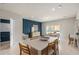 Dining area showcasing a statement wall, dining table, and adjacent living area with natural light at 2582 Winsome Way, Davenport, FL 33896
