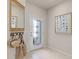 Bright entryway featuring tile flooring, decorative mirror, storage and a modern front door at 2582 Winsome Way, Davenport, FL 33896
