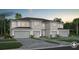 Beautiful two-story home showcasing a manicured lawn, multi-car garage and impeccable modern design at 2582 Winsome Way, Davenport, FL 33896