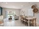 Living room and dining area, featuring neutral decor, plenty of natural light, and stylish accents at 2582 Winsome Way, Davenport, FL 33896