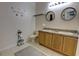 Bathroom with double sinks, a long countertop, modern mirrors, and neutral decor at 2935 Greenwood Springs Loop, Lake Mary, FL 32746
