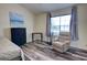 Cozy bedroom with wood-look floors, a comfy chair, and a bright window at 2935 Greenwood Springs Loop, Lake Mary, FL 32746