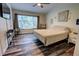 Bright bedroom with large window, dark wood floors, and modern furnishings at 2935 Greenwood Springs Loop, Lake Mary, FL 32746