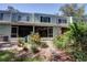 Exterior view of a well-maintained home with lush landscaping and outdoor living spaces at 2935 Greenwood Springs Loop, Lake Mary, FL 32746