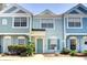 Inviting townhome exterior with colorful facade, well-kept landscaping, and charming curb appeal at 2935 Greenwood Springs Loop, Lake Mary, FL 32746