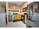 Cozy kitchen featuring wood cabinets, granite countertops, and stainless steel dishwasher at 2935 Greenwood Springs Loop, Lake Mary, FL 32746