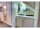 Well-equipped laundry room featuring a washer, dryer, storage shelves, and ample lighting at 2935 Greenwood Springs Loop, Lake Mary, FL 32746