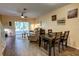 Open-concept living and dining area with modern decor and access to a screened-in patio at 2935 Greenwood Springs Loop, Lake Mary, FL 32746
