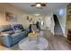 Cozy living area with hardwood floors, comfortable sofa, and staircase access to the upper level at 2935 Greenwood Springs Loop, Lake Mary, FL 32746