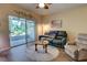 Comfortable living room with tile floors, ceiling fan, and sliding door access to a screened-in patio at 2935 Greenwood Springs Loop, Lake Mary, FL 32746