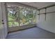 Screened-in porch offering a view of a lush garden, with storage shelves at 2935 Greenwood Springs Loop, Lake Mary, FL 32746