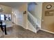 View of the staircase featuring wood floors, and a view to the kitchen and entry way at 2935 Greenwood Springs Loop, Lake Mary, FL 32746