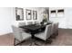 Contemporary dining room features modern decor, wood flooring, and a large table for entertaining at 314 Puma Loop, Groveland, FL 34736