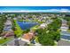 Wide aerial view showcasing houses nestled around a tranquil pond in a suburban setting at 3234 Amberley Park Cir, Kissimmee, FL 34743