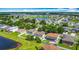 Neighborhood aerial view featuring community lake and residential houses at 3234 Amberley Park Cir, Kissimmee, FL 34743