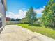 Spacious backyard featuring green grass, concrete patio and wooden fencing at 3234 Amberley Park Cir, Kissimmee, FL 34743