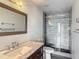 Modern bathroom with stylish vanity, and a glass-enclosed shower with decorative tiling at 3234 Amberley Park Cir, Kissimmee, FL 34743