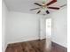 Comfortable bedroom with dark floors, ceiling fan, and easy access to other rooms at 3234 Amberley Park Cir, Kissimmee, FL 34743