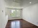 Bedroom with dark wood floors, white walls, and natural light at 3234 Amberley Park Cir, Kissimmee, FL 34743