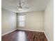 Bright bedroom featuring a ceiling fan and a window offering ample natural light at 3234 Amberley Park Cir, Kissimmee, FL 34743