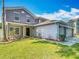 Charming two-story home with landscaped yard and attached two-car garage at 3234 Amberley Park Cir, Kissimmee, FL 34743