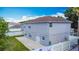 Back of the house with a fenced yard, concrete patio and lush grass at 3234 Amberley Park Cir, Kissimmee, FL 34743