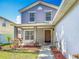 Exterior view highlighting the front entrance, front porch and landscaped garden at 3234 Amberley Park Cir, Kissimmee, FL 34743
