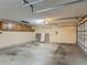 Large empty garage with overhead storage and ample space at 3234 Amberley Park Cir, Kissimmee, FL 34743
