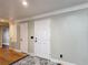 Interior hallway view with hardwood floors, neutral paint, and a decorative floor rug at 3234 Amberley Park Cir, Kissimmee, FL 34743