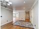 Spacious hallway with hardwood floors, decorative rug, and a view into other rooms at 3234 Amberley Park Cir, Kissimmee, FL 34743