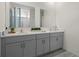 Stylish bathroom featuring double sinks with modern fixtures and gray cabinets at 3318 Arch Ave, Ormond Beach, FL 32174