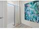 Modern bathroom with glass-enclosed shower, white subway tiles, and decorative wall art at 3318 Arch Ave, Ormond Beach, FL 32174