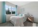 Serene bedroom with a bright window, pastel bedding, and modern decor at 3318 Arch Ave, Ormond Beach, FL 32174