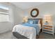 Cozy bedroom featuring a comfortable bed, stylish round mirror, and coordinated nightstands at 3318 Arch Ave, Ormond Beach, FL 32174
