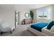 Well-lit bedroom boasts a water view, modern dresser, and sleek furniture at 3318 Arch Ave, Ormond Beach, FL 32174