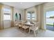 Well-lit dining room with water view, with seating for eight and sliding glass door access to the outside at 3318 Arch Ave, Ormond Beach, FL 32174