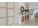 Hallway featuring decoratively paneled wall, white credenza with mirror and contemporary accents at 3318 Arch Ave, Ormond Beach, FL 32174