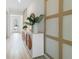 Hallway featuring white credenza with round mirror and decorative vases near entry at 3318 Arch Ave, Ormond Beach, FL 32174