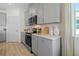 Kitchen featuring stainless steel appliances, gray cabinets, and white countertops at 3318 Arch Ave, Ormond Beach, FL 32174