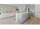 Open concept kitchen featuring stainless appliances, gray cabinets, and an island overlooking the living room at 3318 Arch Ave, Ormond Beach, FL 32174
