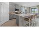 Well-lit kitchen featuring gray cabinets, stainless steel appliances, and a stylish island with seating at 3318 Arch Ave, Ormond Beach, FL 32174