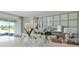 Tastefully decorated living room with vases and wine glasses on display with a TV, table and chairs in view at 3318 Arch Ave, Ormond Beach, FL 32174