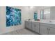 Elegant bathroom featuring a double vanity, quartz countertops, and modern artwork at 3326 Arch Ave, Ormond Beach, FL 32174