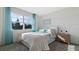 Bright bedroom with large window, blue curtains, and comfortable bed and bedding at 3326 Arch Ave, Ormond Beach, FL 32174