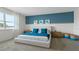 Beautiful bedroom with a blue accent wall, plush bed, and scenic window view at 3326 Arch Ave, Ormond Beach, FL 32174