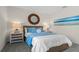 Comfortable bedroom with a stylish woven nightstand, decorative lamps, and serene beach-themed artwork at 3326 Arch Ave, Ormond Beach, FL 32174